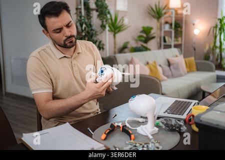 Technician Installing Surveillance Camera at Home Stock Photo