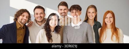 Portraits Of Happy Students Or Coworkers On Grey Stock Photo