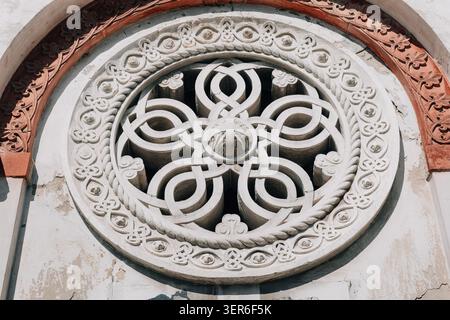 Ornate carved stone tracery forming a geometric pattern, part of an ancient building facade. Celebrating art and craftsmanship Stock Photo