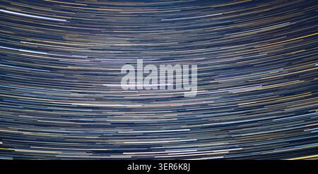 Full-frame star trails background pattern, naturally formed by planet spinning. Total exposure is 42 min. Stock Photo