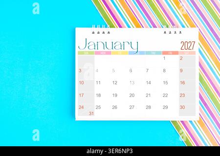 January 2027 desk calendar on white table with pink color background Stock Photo - Alamy