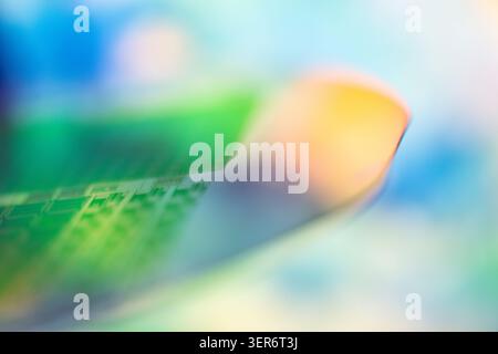 Silicon semiconductor wafer with microchips showing colorful abstract pattern Stock Photo