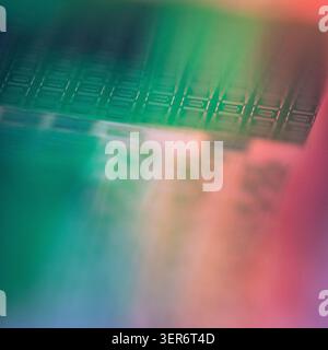 Wafer surface showing electronic chips with colorful reflections Stock Photo