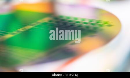 Silicon wafer reflecting iridescent colors and abstract microchip patterns Stock Photo