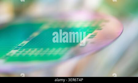 Silicon wafer reflecting light and displaying intricate electronic circuit patterns Stock Photo