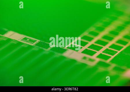 Silicon wafer displaying microchip circuit patterns for modern technology Stock Photo