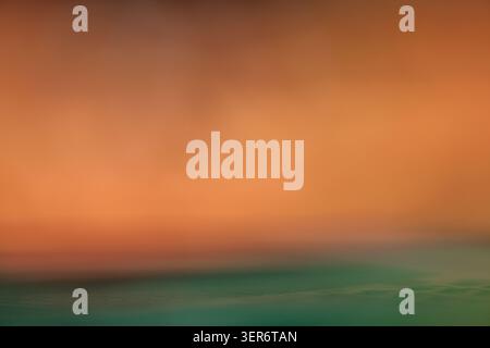 Abstract image showing a soft color gradient with orange and turquoise representing horizon Stock Photo