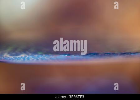 Abstract wafer surface glowing with blue and purple reflections, creating a technological and peaceful background Stock Photo