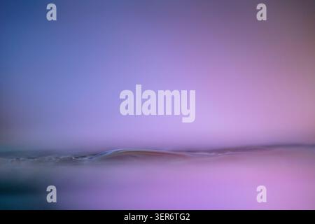 Abstract purple gradient showing a ripple or wave pattern with a zen-like electronic chip feel Stock Photo