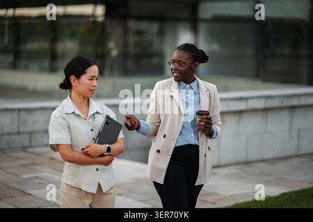 Diverse businesswomen discussing work during outdoor break Stock Photo