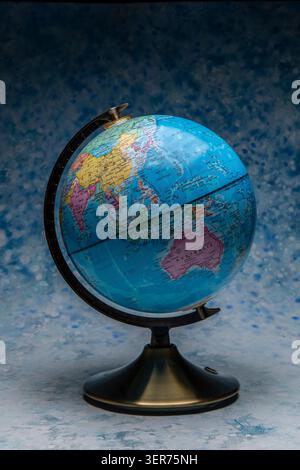 Globe on stand displaying world map for education, travel, and geography Stock Photo
