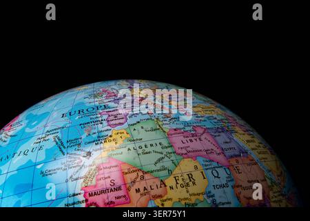 Geographic globe displaying country borders and names for europe and africa on black Stock Photo