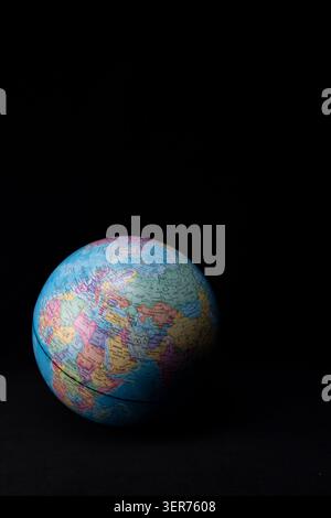 Earth globe illuminated against a dark background, symbolizing global connections and geography Stock Photo