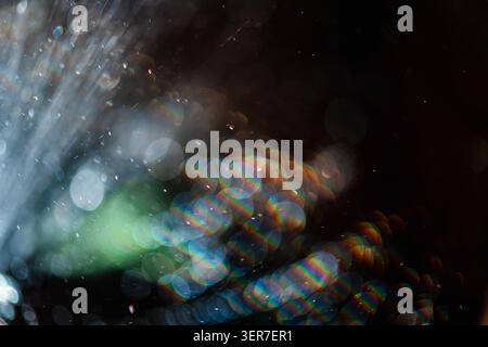Abstract bokeh light particles showing colorful rainbow spectrums, creating a blurred and soft focus background with shimmering effects and dynamic vi Stock Photo
