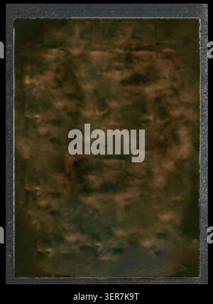 A dark, textured vintage cardboard photo mount with a weathered grunge border, featuring an aged, mottled brown surface perfect for an antique overlay Stock Photo
