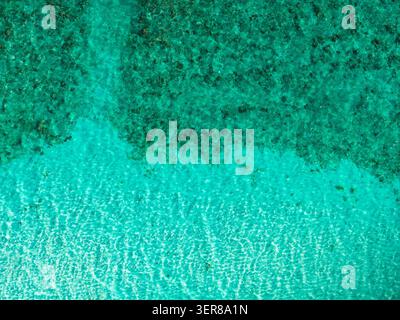 Aerial Maldives reef flat with shallow turquoise to emerald sea Stock Photo
