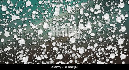 A digital abstract background featuring a dense pattern of textured white circular particles layered over a dynamic, blurred teal and brown gradient. Stock Photo