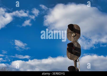 Vintage Railway Signal Against Blue Sky with Clouds Stock Photo