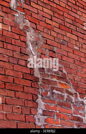 Creative Artsy Vertical Image of an Old Red Brick Wall with White Plastered Repair Stock Photo