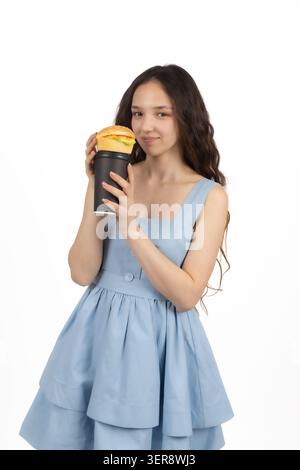 Thirsty young beautiful woman drinking tasty beverage from a tall paper cup Stock Photo