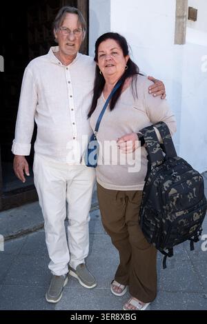 Mature adult woman and man posing for camera, standing close together outdoors Stock Photo