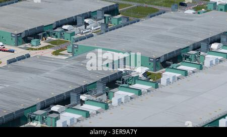 Aerial view of a modern datacenter campus with cooling units and power equipment on rooftops, supporting big data processing, cloud computing, and sca Stock Photo