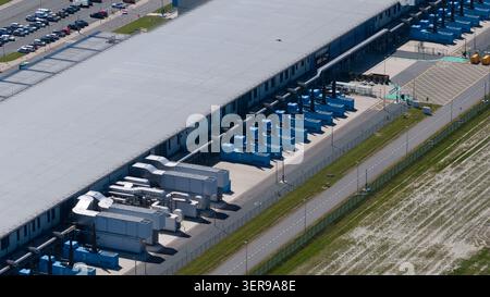 Aerial view of a secure datacenter in Middenmeer with cooling units and infrastructure, supporting cloud storage, big data processing, and machine lea Stock Photo