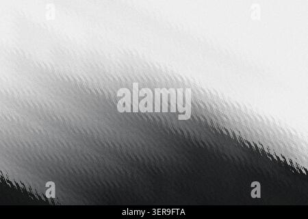 A high-resolution abstract background featuring a diagonal gradient transition from dark charcoal to light gray, characterized by a distinct grainy te Stock Photo