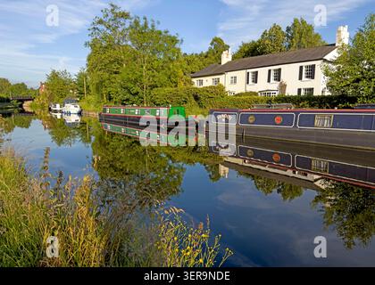 Narrowboats moored on the Bridgewater Canal at Stanney Lunt Bridge, Grappenhall, Warrington, Cheshire, England, UK, looking east. Stock Photo