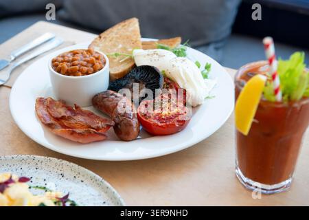 Delicious Breakfast Plate Featuring Poached Eggs and Savory Sides at a Cozy Cafe Stock Photo