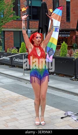 Fire eater in rainbow costume performing at Warrington Pride 2026 in Warrington town centre, Cheshire, England, UK. Stock Photo