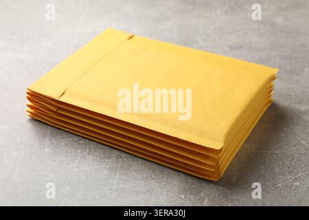 Stack of yellow envelopes on grey table, closeup Stock Photo
