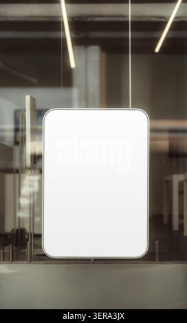 Empty rounded lightbox sign behind a glass storefront window, ideal for logo, poster or retail advertising mockup with blurred interior lighting Stock Photo