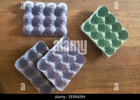 Recycled egg cartons on a wooden table Stock Photo