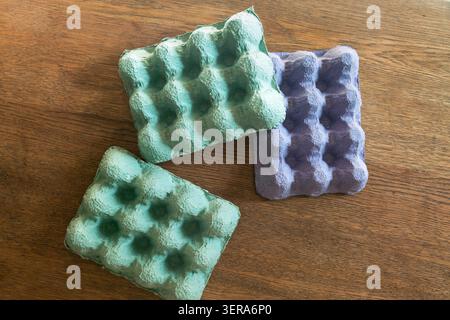 Pastel colored molded paper pulp egg cartons displaying recycled material texture Stock Photo