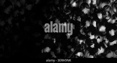 A black and white abstract image showing a complex arrangement of overlapping circles with dramatic light streaks creating a high-contrast effect. Stock Photo