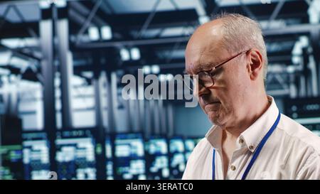 Competent professional in data center, solving tasks on tablet while running scripts on laptop terminal, skillful developer amidst servers, accessing databases and manipulating lines of code. Stock Photo