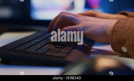 Computer peripheral used by IT admin to type lines of code on desktop PC in apartment, close up shot of keyboard used by software engineer programming at home. Stock Photo