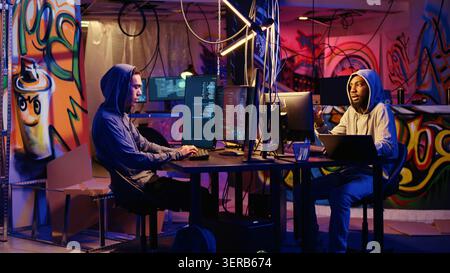 Hackers developing zero day exploit undetectable by antivirus software installed on systems in order to steal valuable data from users, rogue programmers in hideaway look for ways to trick firewalls. Stock Photo