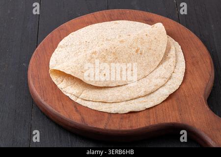 Stack of Fresh Whole Wheat Tortillas and Multi-grain Wraps on Wooden Board. Healthy Unleavened Flatbread, Asian Style Pancakes. Stock Photo