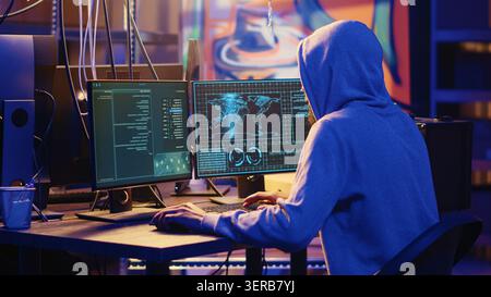 International spy using VPN and darknet as anonymity tools to mask his online identity while stealing governmental secrets, man in underground bunker masking his location, committing espionage acts. Stock Photo