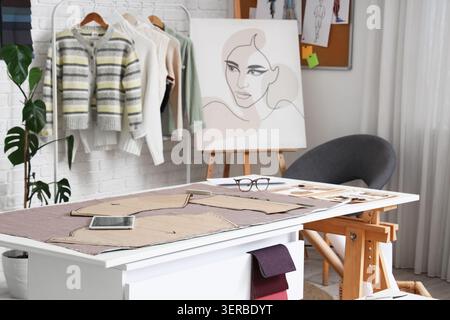Fabric with patterns on table in fashion designers studio Stock Photo