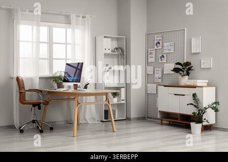 Interior of data scientists office with workplace, pin board and diagrams Stock Photo