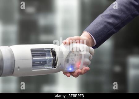 Robotic arm shakes hands with its partner Stock Photo
