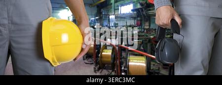 Closeup of workers in manufacturing plant Stock Photo