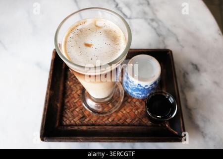 Top view of Iced latte coffee and hot black coffee with tea in a woven tray in cafe of Thailand Stock Photo