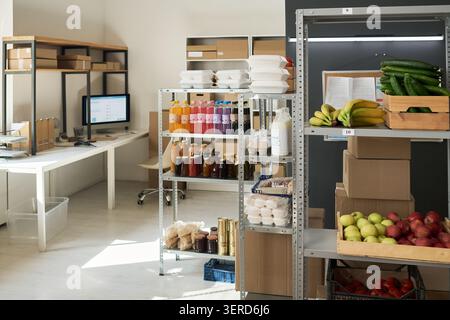 Order Pickup Point Stocking Fresh Produce and Packaged Food Stock Photo