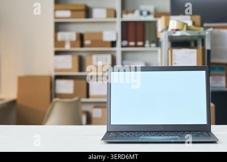Laptop Displaying Blank Screen in Order Pickup and Delivery Office Stock Photo
