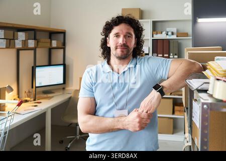 Portrait of Man Working at Order Pickup Point in Warehouse Stock Photo