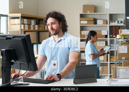 Man Working at Order Pickup Point for Food Delivery Service Stock Photo
